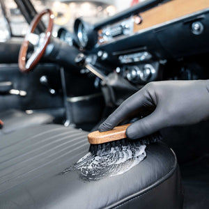 Detailing1 COLOURLOCK Classic Car Leather Care Set — brushing a classic car's leather seat clean