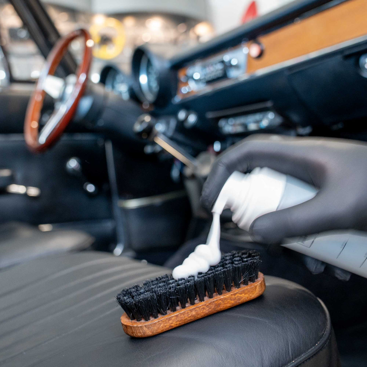 Detailing1 COLOURLOCK Classic Car Leather Care Set — cleaning foam onto the leather brush in a classic car